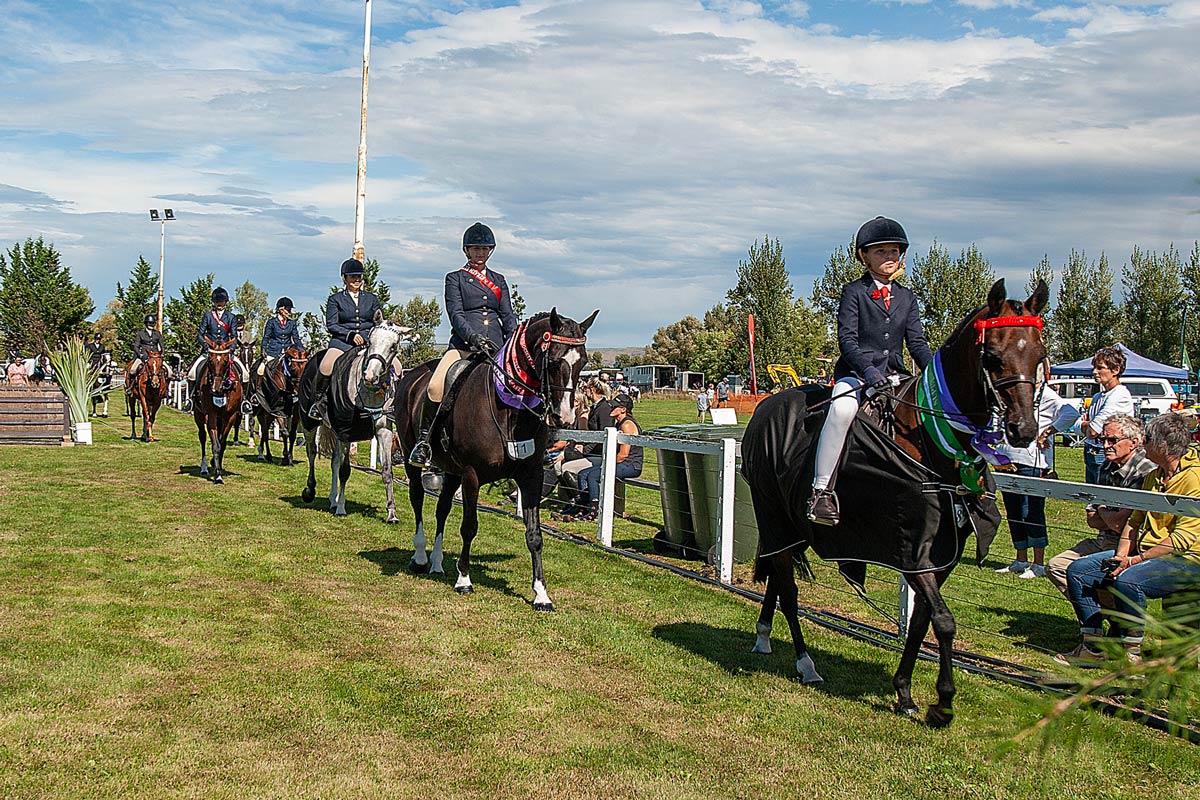 Grand Parade at the Strath Taieri Agricultural and Pastoral Show in Middlemarch at Show Grounds. Horses and Riders showing their prizes. This happens every Sunday of Otago Anniversary weekend.