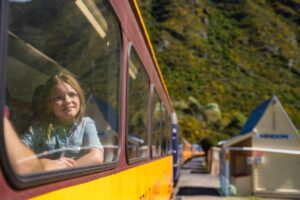 Kid enjoying views from Taieri Gorge Train on way to Pukerangi, Middlemarch